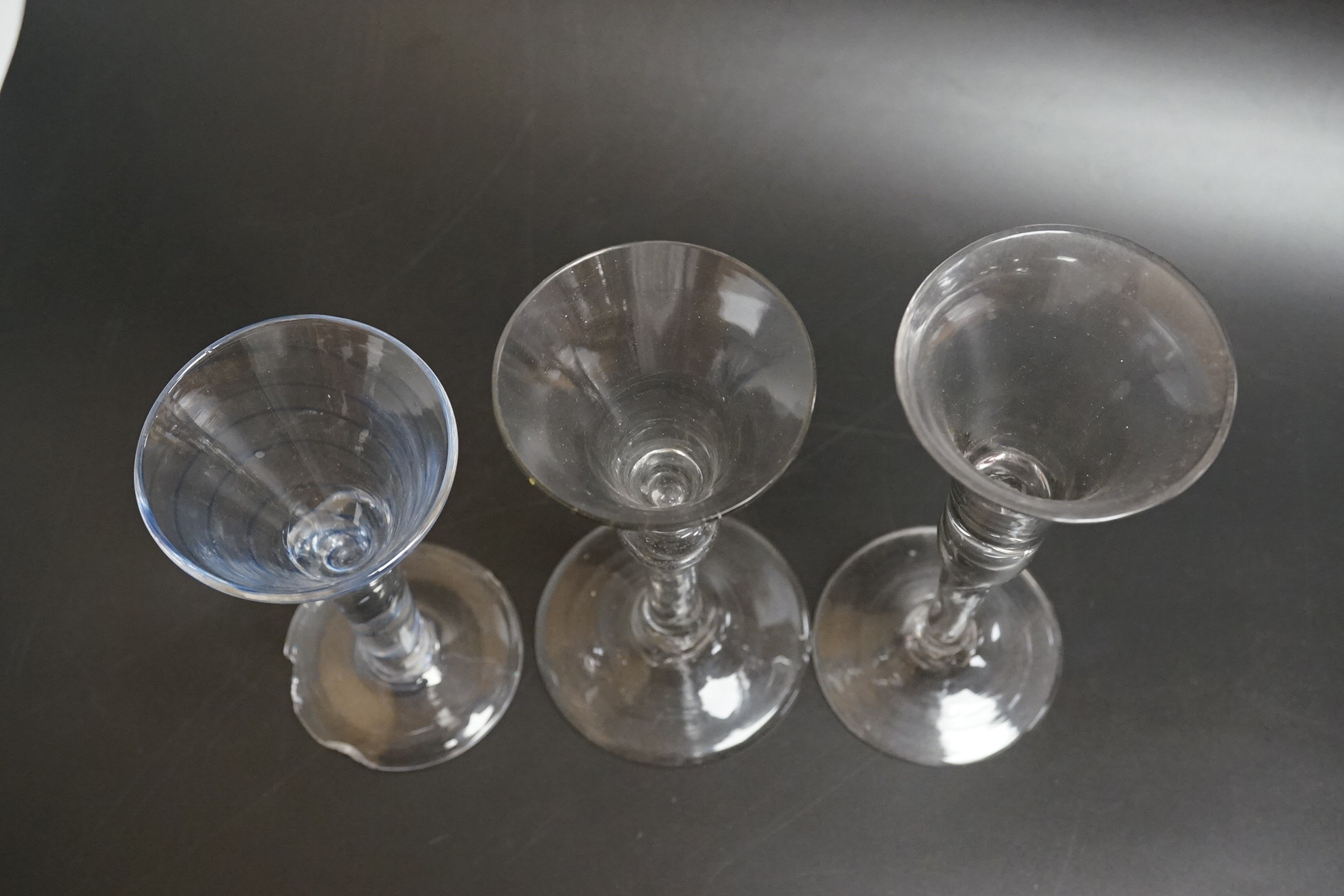 Two drawn wine glasses, each with air-tear stems, and a drawn-stem wine glass with blue internal twist, tallest 17cm high (3)